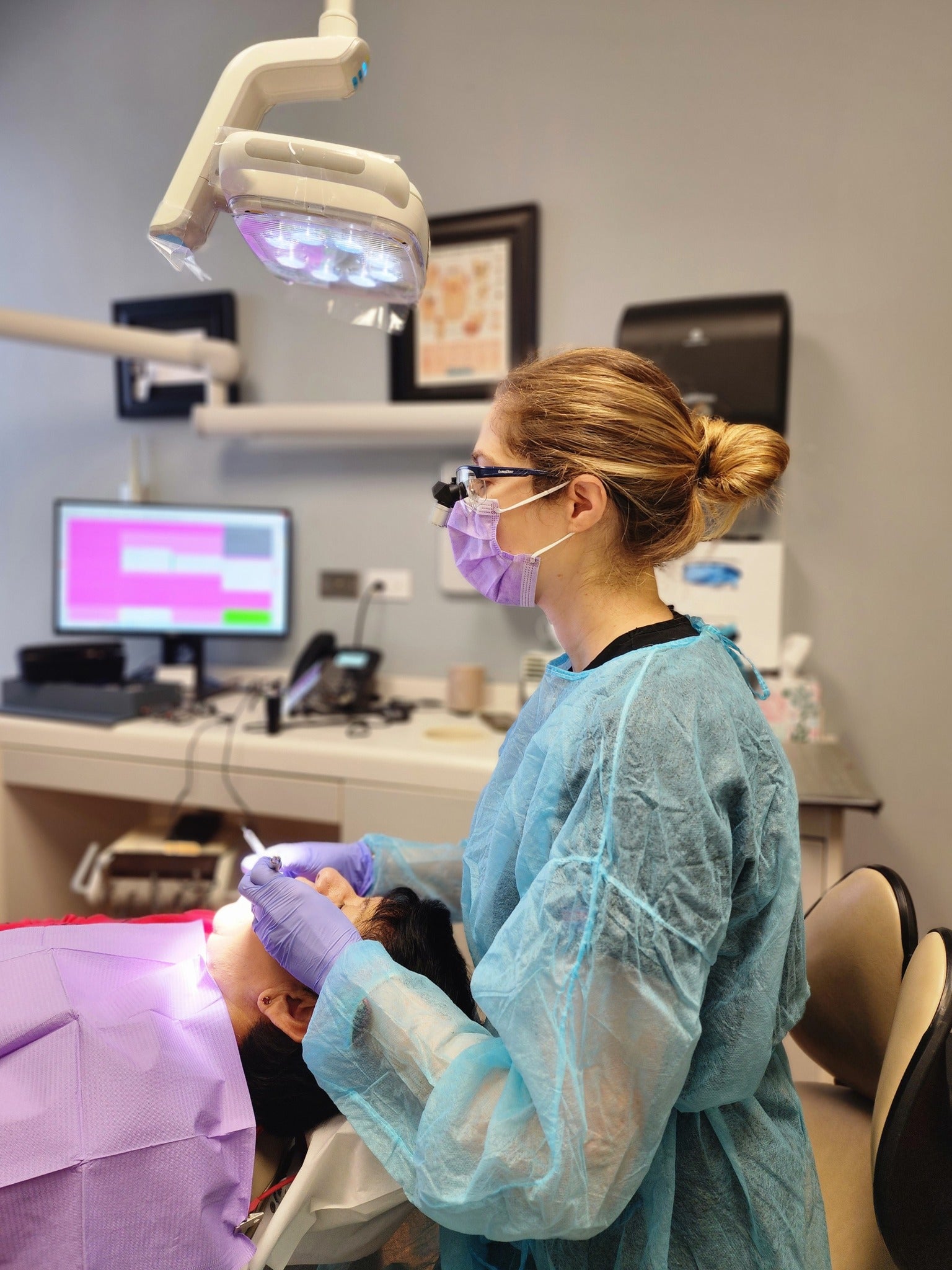 Dental Hygienist working on patients with Ergo Loupes. 