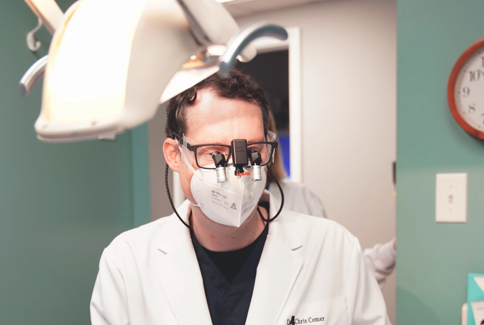 Image of Surgeon working on patient with LumaDent Ergo Loupes. 